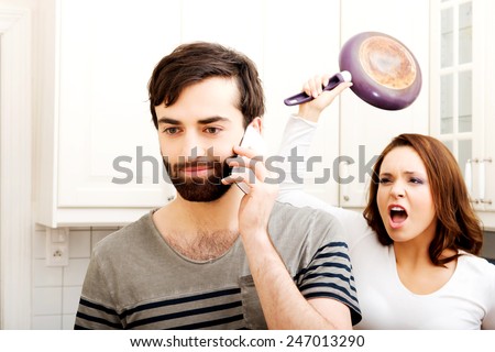 stock-photo-young-rage-woman-hitting-her-talking-partner-with-frying-pan-247013290.jpg
